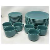 Group of teal ceramic plates, teacups and saucers