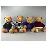 Four Plush Teddy Bears in Sweaters
