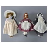Three Porcelain Dolls in Period Attire