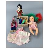 Assortment of Dolls and Clothing