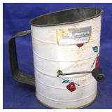 Painted vintage metal flour sifter