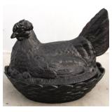 Black glass hen on the nest