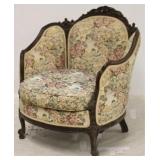 Ornately carved barrel arm chair in tapestry