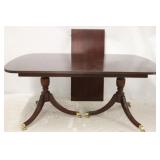 Mahogany dining table on brass casters w/ leaf