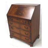 Slant front mahogany desk with leather surface