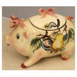 Painted ceramic pig with wear