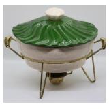 Vintage covered casserole in warmer rack