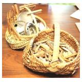 2 hand woven baskets full of assorted items
