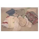 Lot of assorted doilies, apron, bonnet, & more