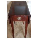 Drop-side one drawer table