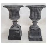 Matching pair cast iron urns on bases