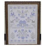 Needlepoint sampler in frame