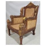 Heavily carved caned arm chair