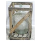 Large wine bottle in wooden crate