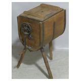 Primitive wooden churn on legs