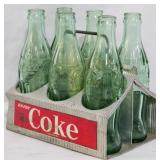 6 Coca Cola Bottles in Metal Rack