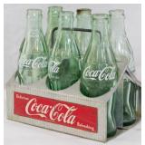 6 Coca Cola Bottles in Metal Rack