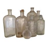 9 Clear Assorted Bottles - 9.5" Tall