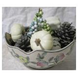 Bowl with fruit and pinecones