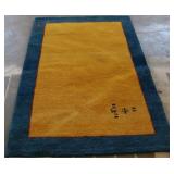 Blue trimmed yellow rug