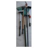Group of garden rakes and brushes