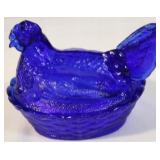 Cobalt blue hen on a nest