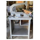 Gray Scroll Saw on Wooden Stand