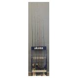 (8) Different Fishing Rods w/ Reels & Stand