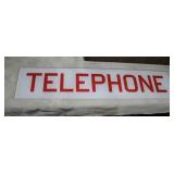 glass telephone sign from a telephone booth