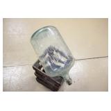 embossed glass bottle with >>