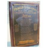 bronze on wood plaque >