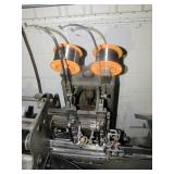 machine with two stitch heads>