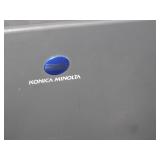 mfgd by Konica Minolta, and >