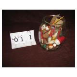 Glass container full of fishing items
