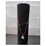 Turquoise Enclosed in Gold Plated Leaf Pendant