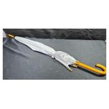 Umbrella with metal and wood frame and handle.