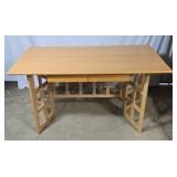 Folding table in light wood with two drawers.