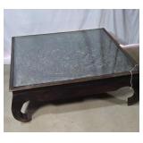 Hand carved wood coffee table with glass top..