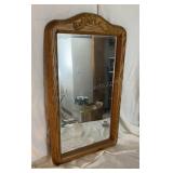 Wooden framed wall mirror. Approximately 17"x29"