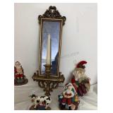 vintage-style mirrored candle sconce. It is wall