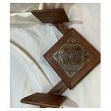 Decorative wooden wall display with shelves.