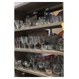 Assorted glassware on three shelves.  Buyer takes