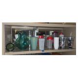 Shelf lot of plastic cups and pitchers. Buyer