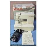 Singer "Tiny Tailor" sewing machine.  Includes