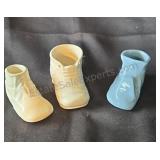 Ceramic shoe shaped baby vases.