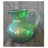 Hand blown green glass pitcher. 10x8.