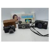 3 vintage cameras and flash bulbs