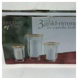 Holiday time 3 gold rimmed glass candle holders.