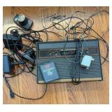 Vintage Atari 2600 console and game with cords