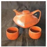 Glazed ceramic teapot with two cups